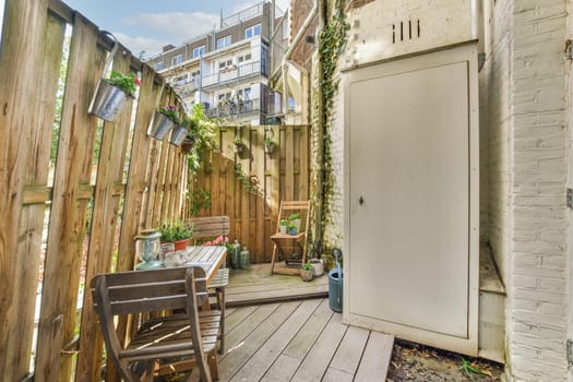 a small backyard with a wooden fence and a door