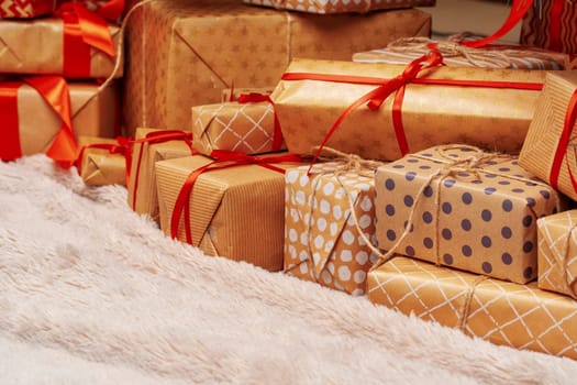 Stack of christmas gifts on beige carpet