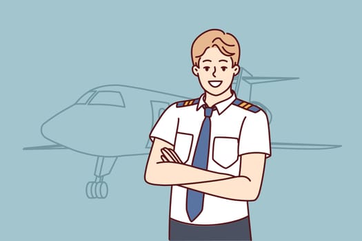Man pilot of airplane stands with arms crossed near airliner inviting to buy new airline ticket