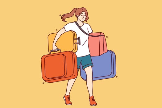 Woman carries lot of tourist suitcases when going on long trip or changing places of residence