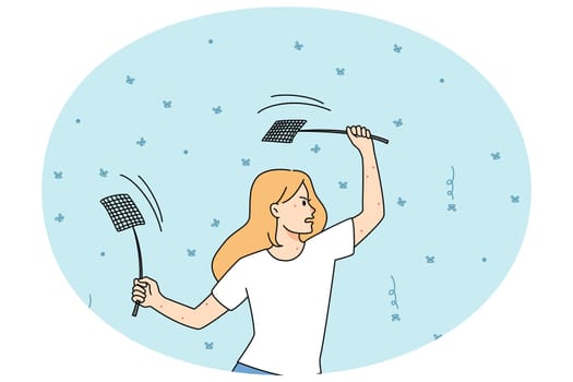 Woman with fly swatters killing mosquitos