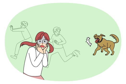Scared children run away from barking dog