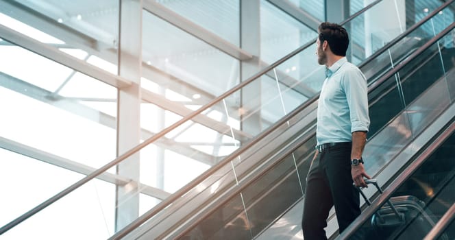 Airport, travel and a business man on escalator with his luggage for a trip abroad or overseas. Corporate, global and suitcase with a male employee in a terminal for an international work flight