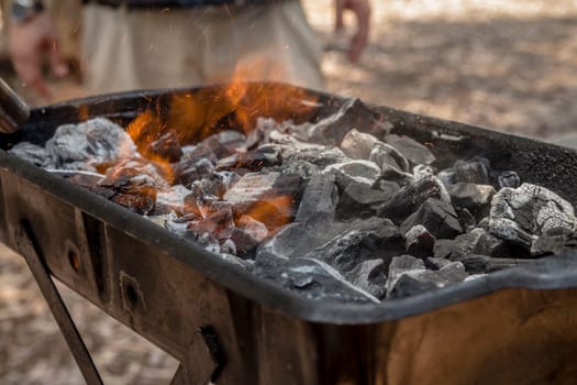 Coals are burned in a BBQ grill