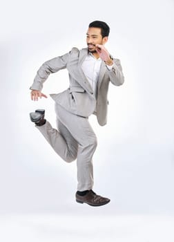 Running, rush and business man late for work jumping, hurry and sprint for appointment in studio. Corporate mockup, time management and Asian male isolated on white background in run to workplace
