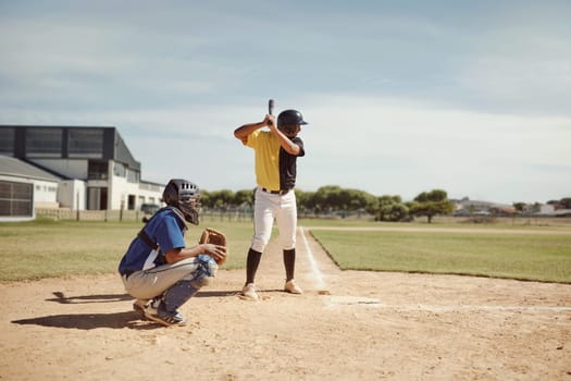 Baseball player, baseball team and man with bat on baseball field ready for training game, competition or match. Fitness, teamwork and baseball batter with team for sports workout outdoors on pitch.