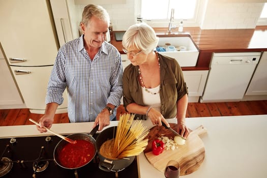 Top view, happy or old couple kitchen cooking with healthy food for lunch or dinner together at home. Love, help or senior woman smiling or talking to mature husband in meal preparation in retirement