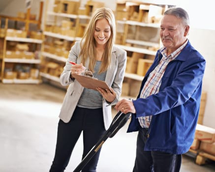 Weve got all your import and export needs covered. a manager talking with a floor worker in a distribution warehouse.