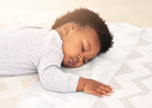 Baby, african boy and sleeping on bed for rest, health and peace for growth, development and relax in family home. Black male infant, tired and sleep in bedroom with fatigue, quiet and calm in house