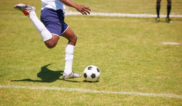 Feet, soccer player and penalty kick on field for goal, competition or game for sports career. Man, football and shooting ball on grass pitch with accuracy for training, workout and contest outdoor