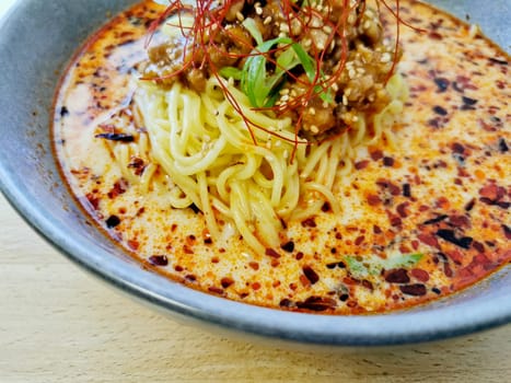 Fire spicy red minced pork tan tan ramen Japanese noodle soup served hot