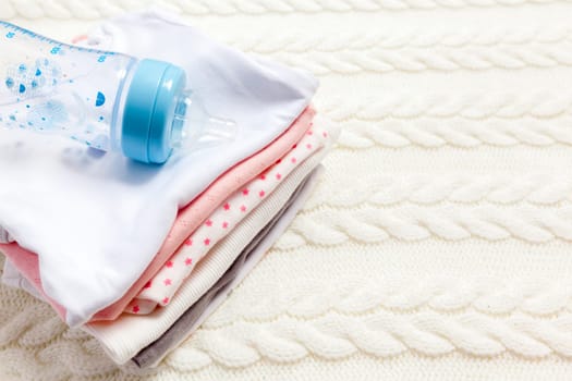 close up of baby clothes for newborn on table
