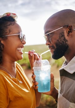 Couple, outdoor and share drink with straw together in summer with smile in sunshine. Man, black woman and happy for soda, juice or slushy on travel, road trip or vacation in countryside on holiday.