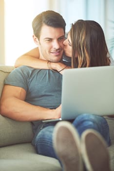 Romance and relaxation. a young couple using a laptop at home.