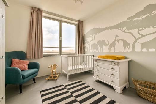 a nursery with a baby crib and a dresser