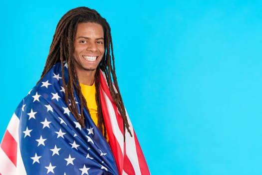 Latin man with dreadlocks wrapping with north america national flag