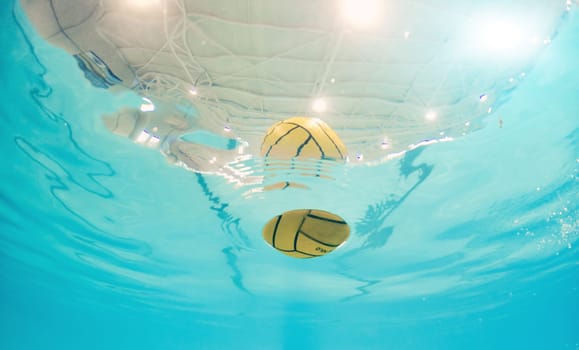 Water polo, sport and ball in a pool from below with equipment floating on the surface during a competitive game. Fitness, training and exercise while a still life object floats during a match