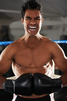 evil boxer. a fierce young male boxer standing in a corner of a boxing ring.