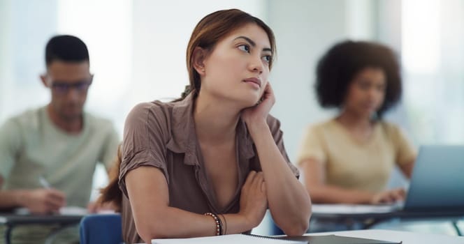 Education, depression and girl university student in a classroom bored, adhd or daydreaming during lecture. Thinking, anxiety and female learner distracted in class, contemplation, boredom or sad