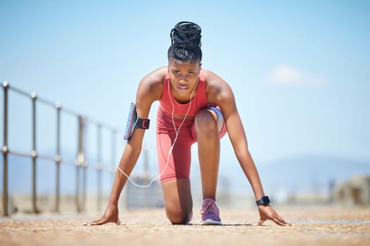 Black woman, fitness and start for running exercise, workout or marathon training in nature. African American female competitive runner preparing for exercising run, sprint or race in the outdoors