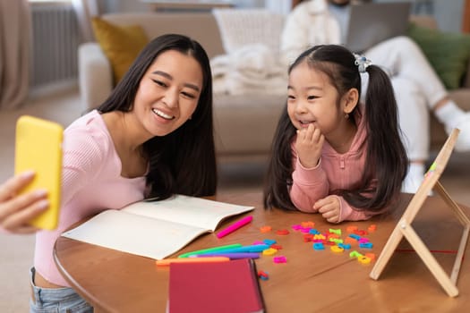 Japanese Mom Making Selfie Teaching Daughter To Read At Home