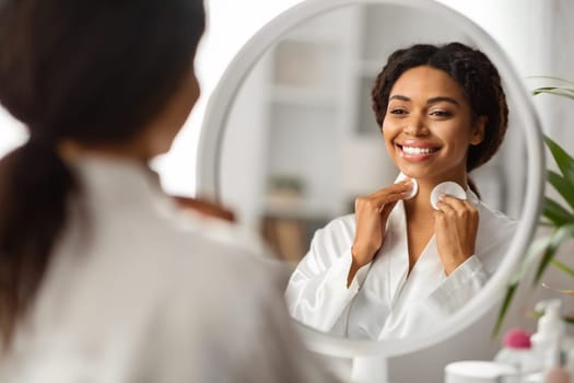 Smiling Black Woman Cleansing Neck Skin With Cotton Pads