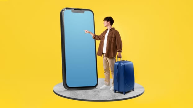 Traveler Man Booking Tickets With Giant Smartphone On Yellow Background