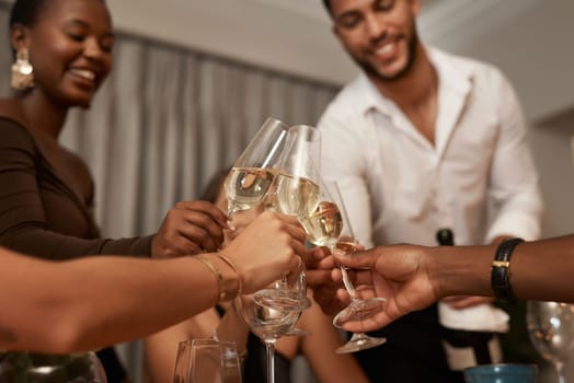 Diverse group, champagne toast and New Years eve party in a house for fun and celebration. Wine, glasses and multiracial people celebrating and cheers with drink at a social gathering while partying