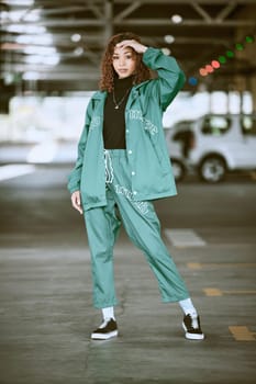 Urban, fashion and girl portrait at parking lot in New York with edgy athleisure style. Gen Z, trendy and statement clothes of young city woman with assertive, confident and cool pose.