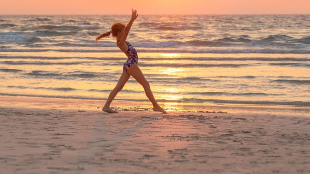 Teen girl doing exercise on the beach