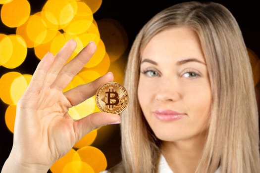 Woman holding a physical bitcoin cryptocurrency