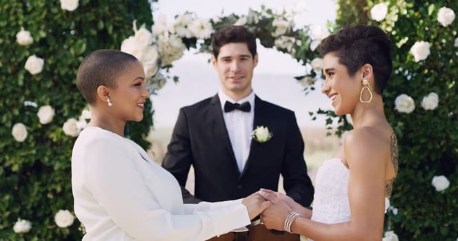 Love, holding hands and smile with lesbian couple at wedding for celebration, gay and pride. Lgbtq, spring and happiness with women at marriage event for partner commitment, care and freedom