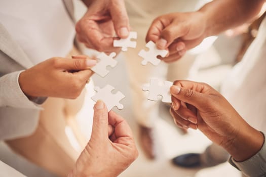 Team collaboration hands, teamwork and puzzle piece showing office community and innovation. Diversity, partnership and project management staff doing work productivity and business development