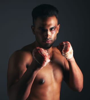 Fight, bruise and bandage with fighter, blood and injury from mma or boxing against a dark studio background. Strong athlete or boxer portrait with wound on hands and eye from fighting or battle
