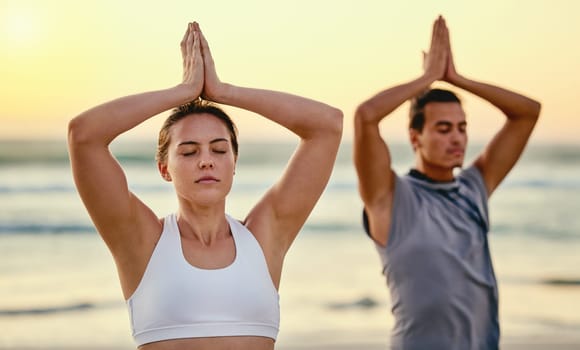 Prayer hands, yoga meditation and couple at beach outdoors for health and wellness. Sunset, pilates fitness and man and woman with namaste hand pose for zen chakra, training and mindfulness exercise.