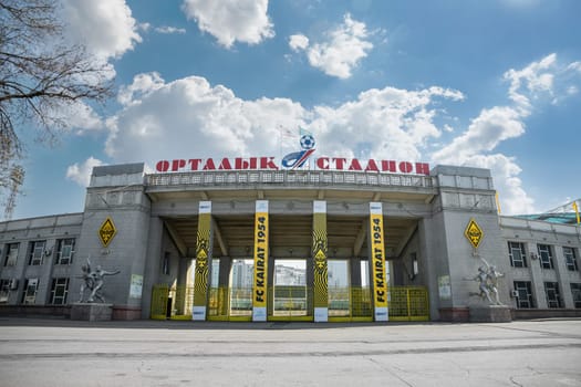 The main entrance of the central sports stadium of Almaty with the symbols of the football club Kairat