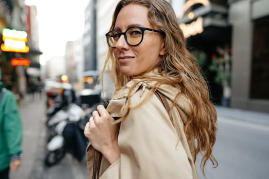 Portrait of caucasian female business person in eyeglasses on city street