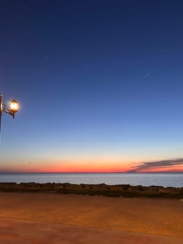 Orange glow on the sea horizon after sunset, mobile photo