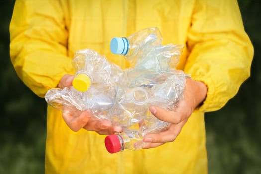 Volunteer hands holding bottle plastic garbage. Environment clean up park cleaning trash nature. Volunteer cleaning forest. PET waste plastic hand trash pick up garbage nature. PET plastic pollution