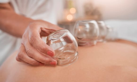 Relax, health and cupping therapy with woman in spa for alternative medicine, healthcare and healing. Peace, skincare or luxury with patient and hands of massage therapist for beauty, zen or holistic.