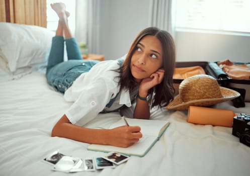 Bed, woman thinking and writing in notebook for travel vacation, adventure and photography memories in hotel bedroom. Young girl, relax and write traveling notes in journal or journey destination