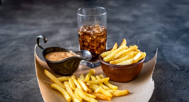 Tasty french fries with drink and sauce