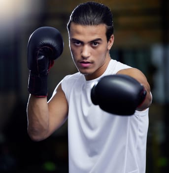 Gym, fitness and portrait of man boxing with focus and motivation for health, training and self defense. Workout goals, exercise and wellness, strong boxer at city studio or club with boxing gloves.