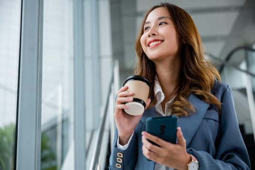 Girl using smartwatch as phone holder while holding coffee cup