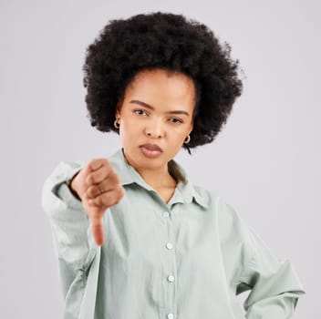Portrait, thumbs down and black woman serious in studio isolated on a white background. Hand gesture, person or female with dislike emoji, negative opinion or no, rejection or failure, vote or wrong.