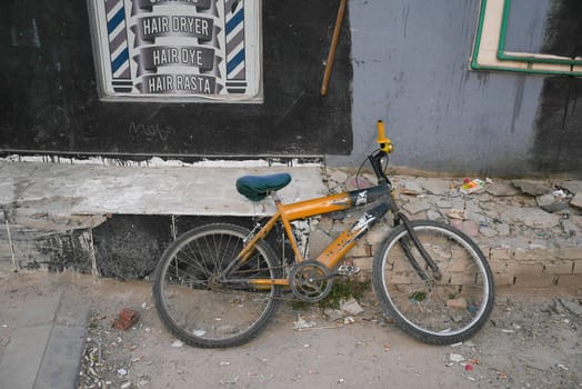 Broken down abandoned bicycle in poor neighbourhood