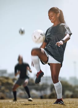 Football, sports and training with woman juggling with knees for workout, exercise and fitness on field. Health, wellness and practice with athlete and soccer ball for game, goals or cardio lifestyle