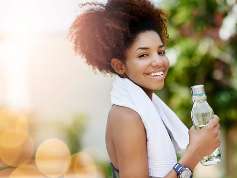 Water is the most important nutrient for active people. Cropped shot of a young woman enjoying a bottle of water while out for a run.