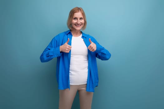 energetic 50s woman in an attractive look on a blue background with copy space