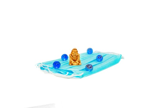 Protective blue mask with a Buddha figure and blue balls